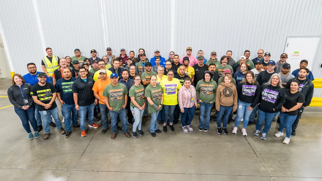 Employees with safety shirts posing