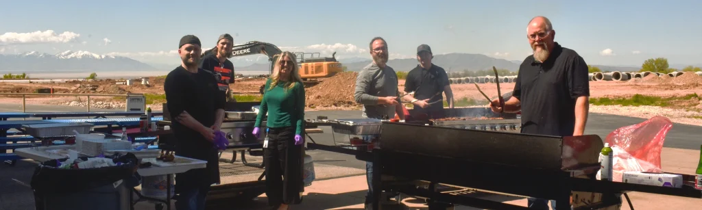 Janicki Utah employees grill food for the Cinco De Mayo luncheon