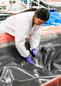Karissa lays up a composite part