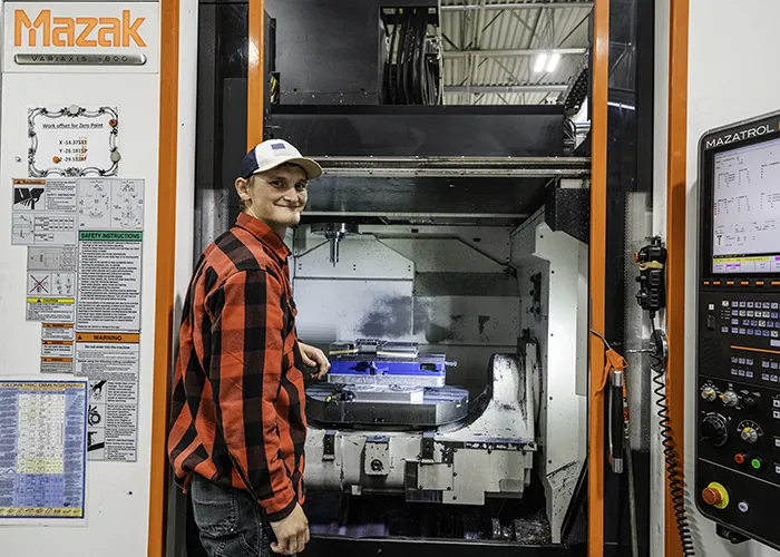 Shayne poses with a Mazak mill