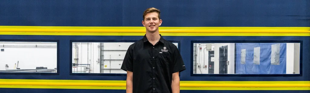 Cory posing in front of overhead door