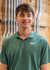 Ethan posing for a photo with a green shirt on