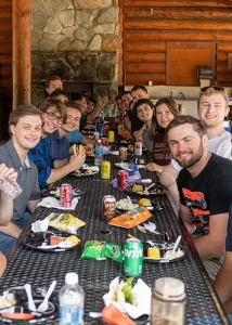 Interns pose for a photo while eating at the picnic