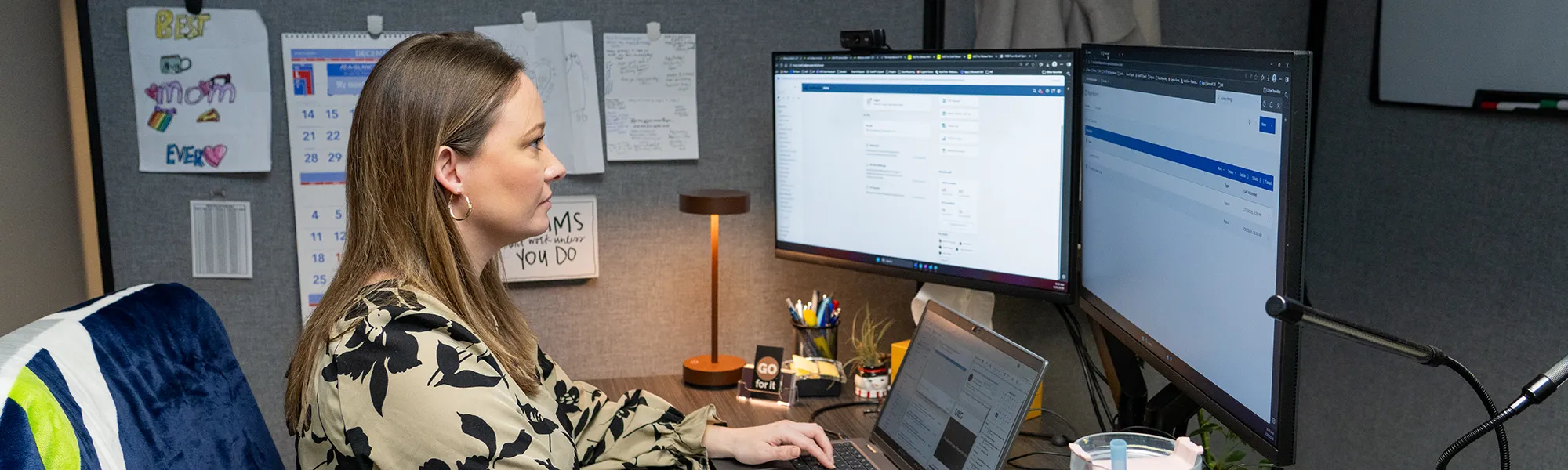 HRIS Analyst. Rebecca, works on a UKR report on her computer