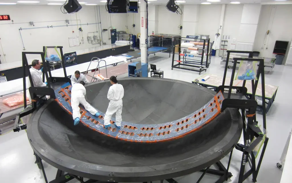 Technicians from Janicki Industries in Hamilton, Washington, position the layers of the diaphragm for the Orion stage adapter. The adapter will join the Orion spacecraft to the interim cryogenic propulsion stage (ICPS) of the Space Launch System, NASA's new rocket for the journey to Mars.