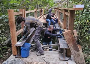 Janicki employees work to construct the Olmsted Park bridge.
