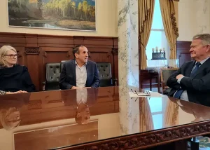 John and Katy Janicki sit at a table next to Idaho Governor Brad Little