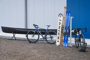 A canoe, road bike, cyclocross bike, snowboard, downhill and crosscountry skis made by Janicki
