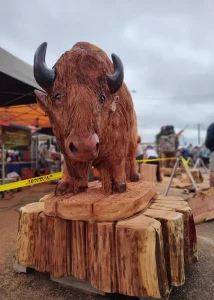 Large wooden carving of a bison